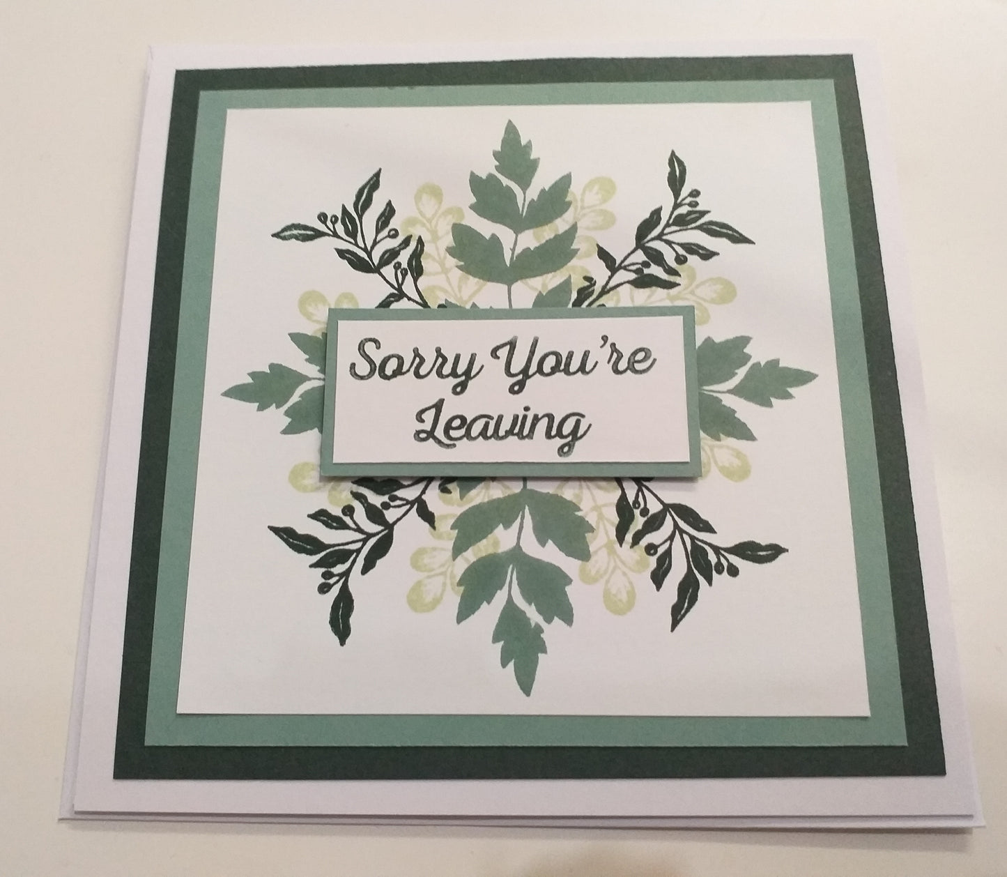 Card with 'Sorry You're Leaving' text on a floral background