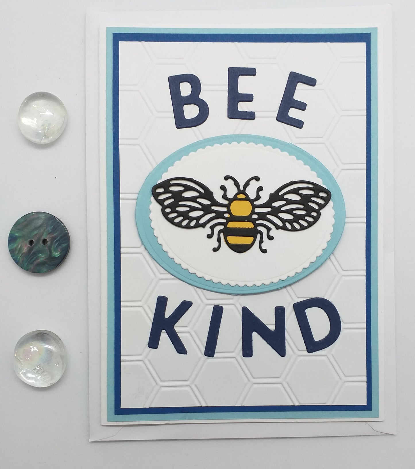Card with 'Bee Kind' text and a bee illustration on a floral background