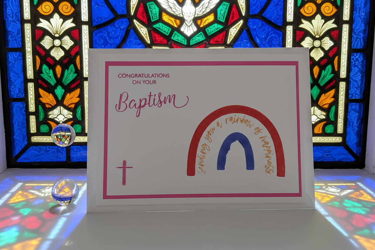 Greeting card with 'Congratulations on your Baptism' text and rainbow design in front of a stained glass window.