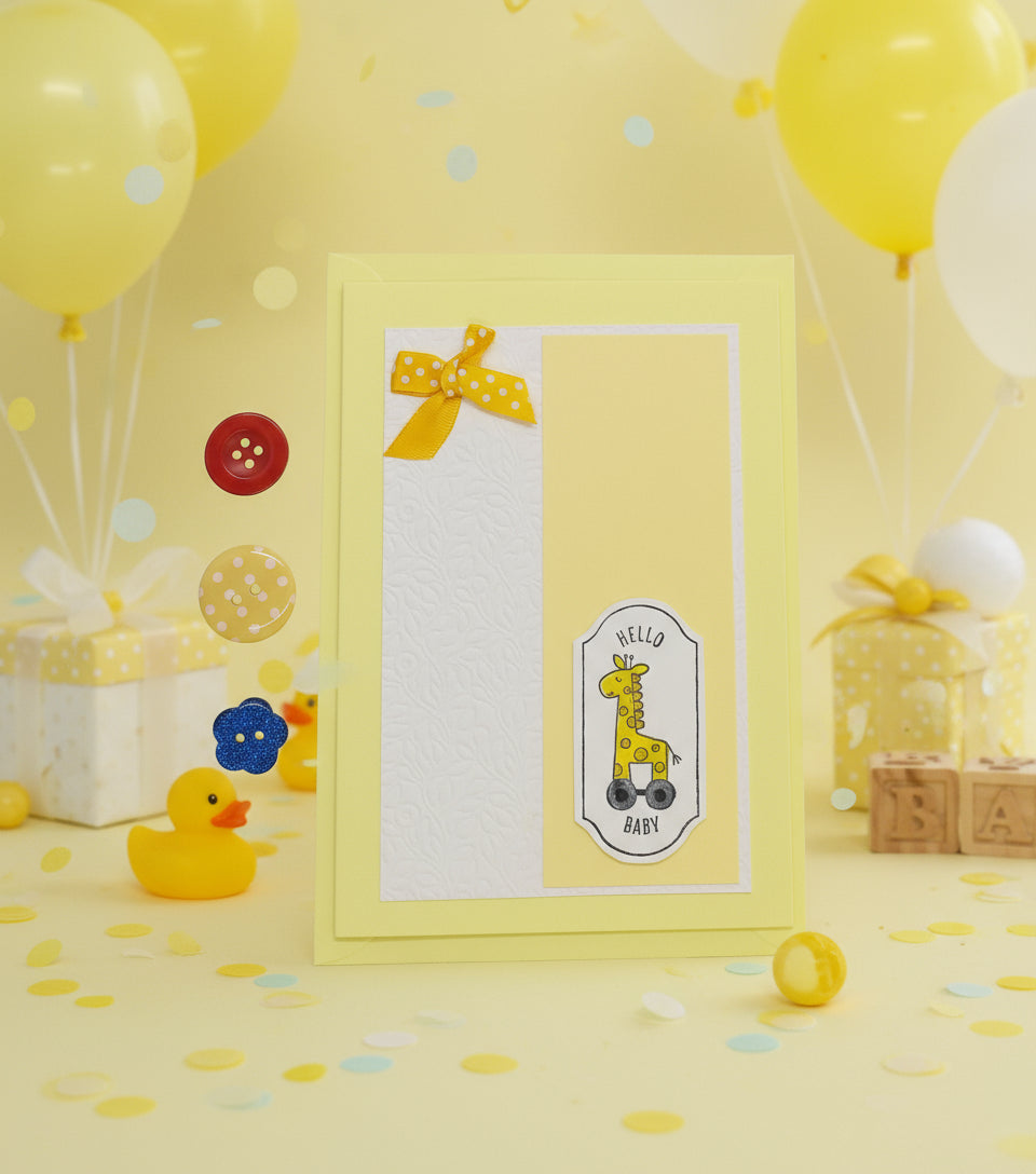 Baby shower card with a giraffe illustration on a yellow background with balloons and gifts.