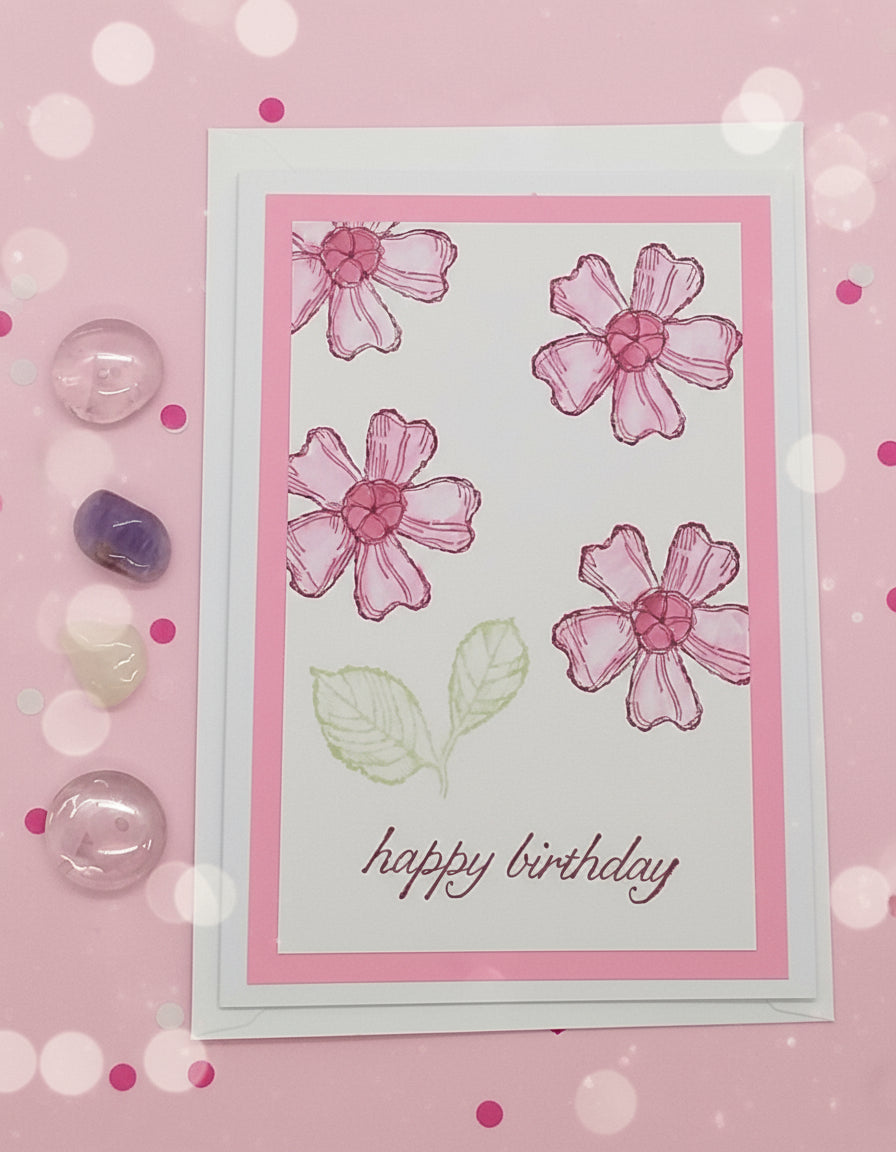 A pink floral Happy Birthday card with an envelope, featuring stamped images and layers.