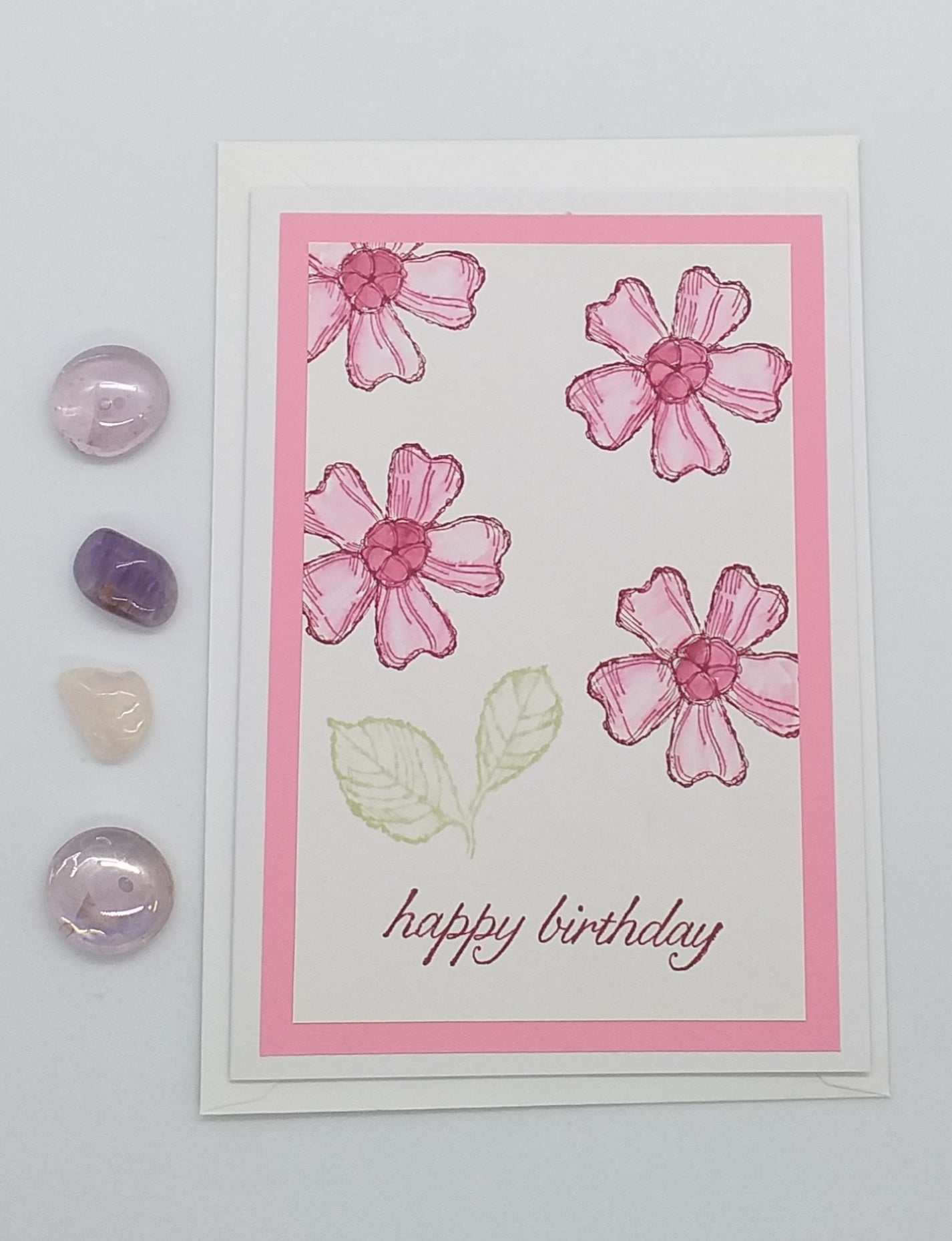 A pink floral Happy Birthday card with an envelope, featuring stamped images and layers.