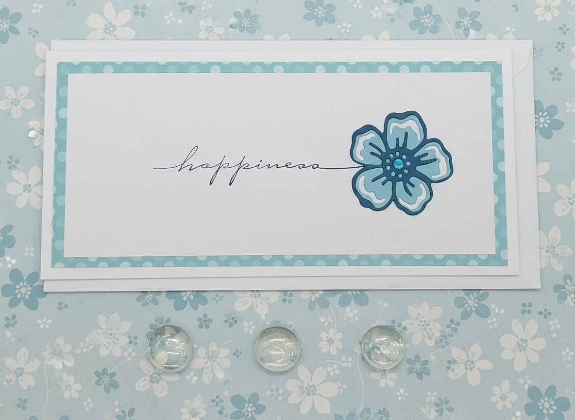 Card with blue flower and 'happiness' text on a floral background