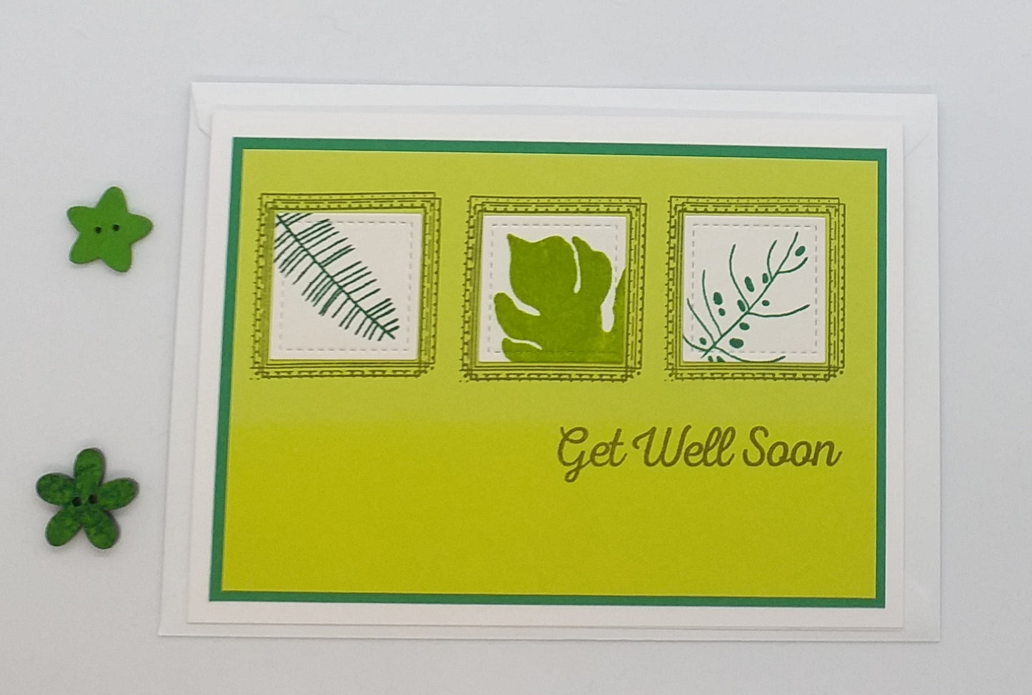Greeting card with leaf designs and 'Get Well Soon' text on a green background