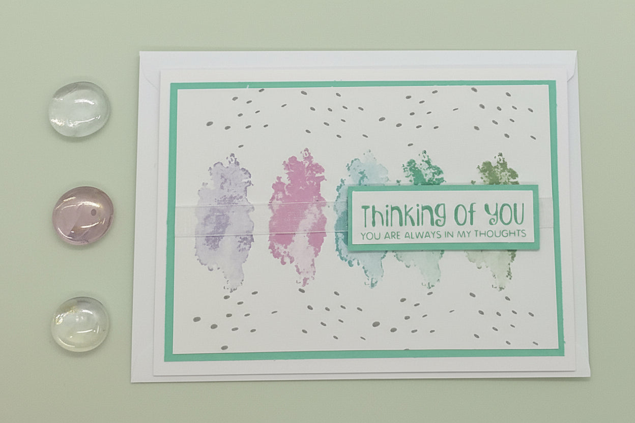 Greeting card with 'Thinking of You' message on a light green background