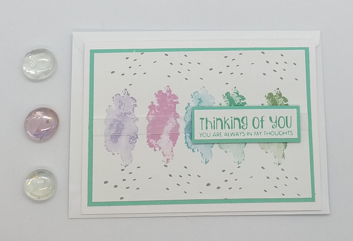 Greeting card with 'Thinking of You' message on a light green background