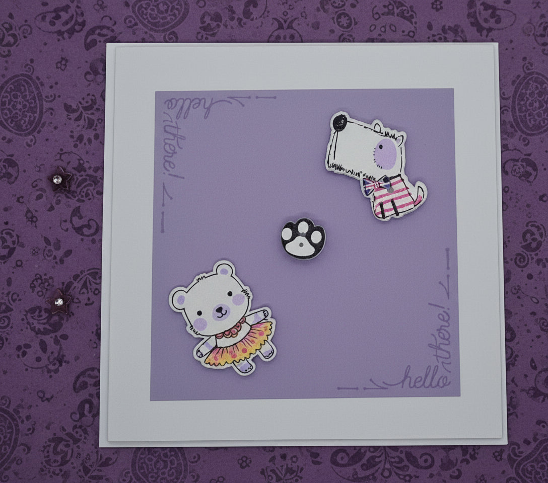 A purple greeting card with two cartoon-style dogs and a paw print, featuring a blank interior and envelope
