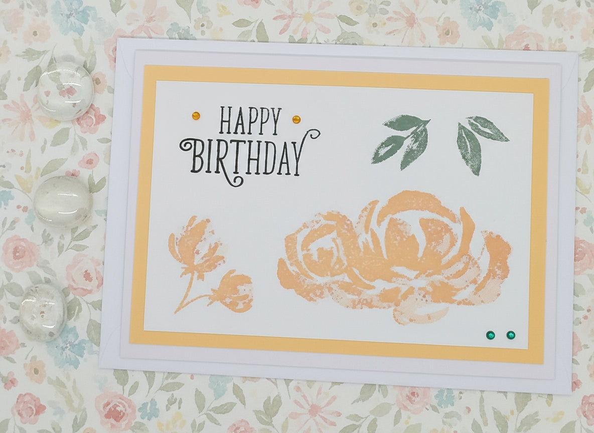 Birthday card with floral design and 'Happy Birthday' text on a floral background