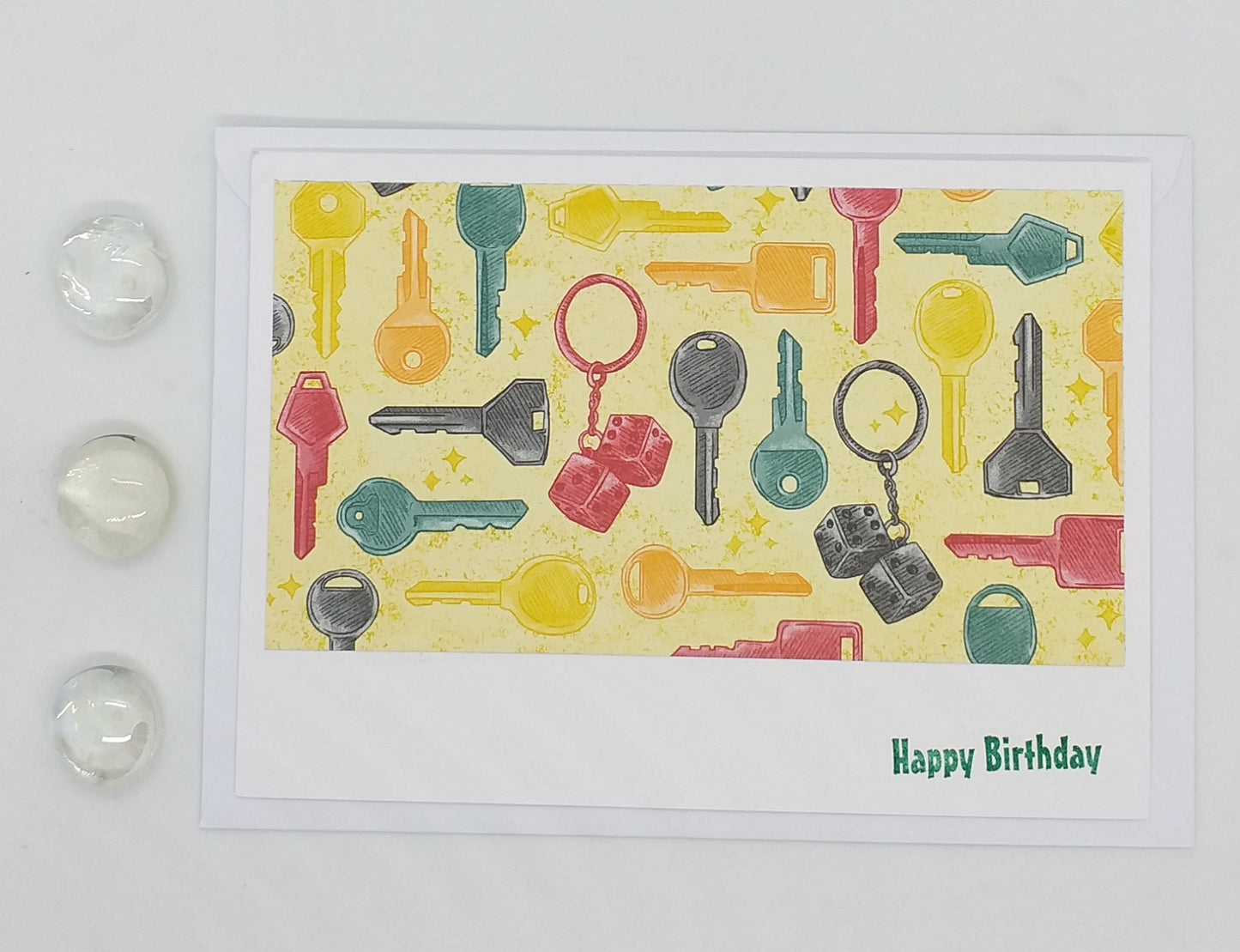 Colorful key pattern on a birthday card with 'Happy Birthday' text, surrounded by decorative items.