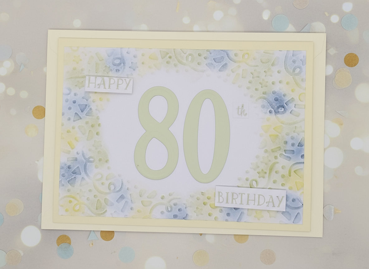 A colorful embossed birthday card with the number 80 and the words 'Happy 80th Birthday' on the front, accompanied by three decorative seals.