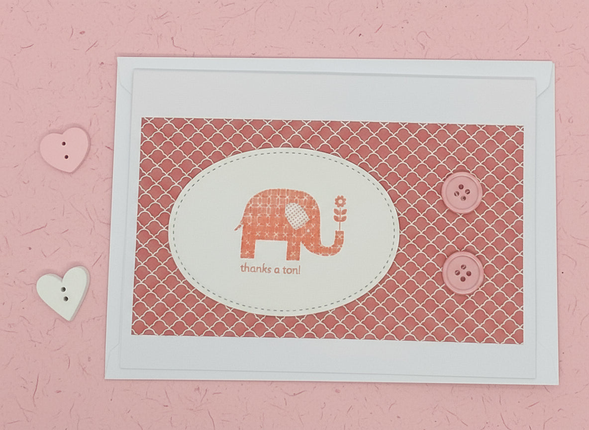 A6 size greeting card with an elephant design, adorned with buttons and accompanied by an envelope and a blank interior for a personal message.