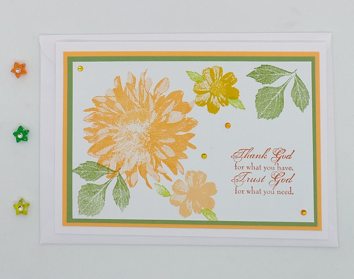 A handcrafted greeting card with a floral design and a message that reads 'Thank God for what you have, Trust God for what you need.'.