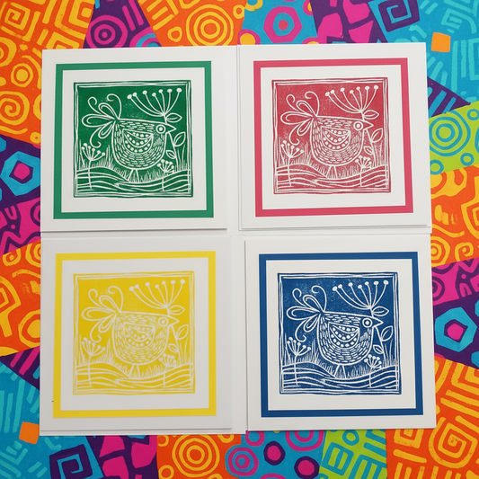 Four colorful prints of a stylized animal design on a multicolored patterned background.