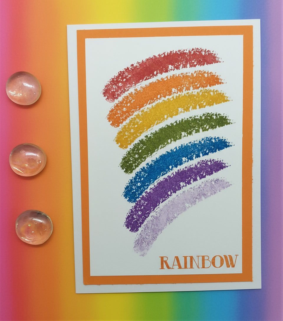 Card with rainbow-colored crayon strokes and 'RAINBOW' text on a colorful background