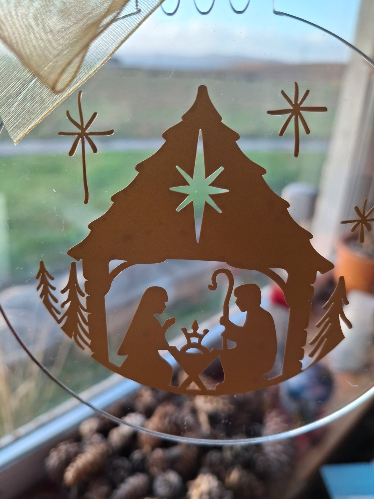 Decorative glass with cut-out design of a fish and starfish on a blurred natural background