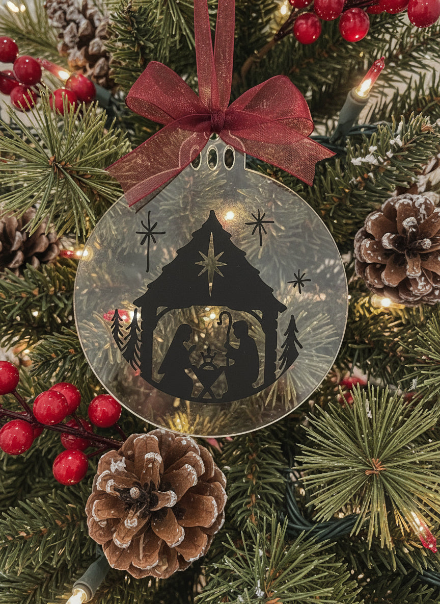 Decorative Christmas ornament with nativity scene silhouette and red bow on a white background