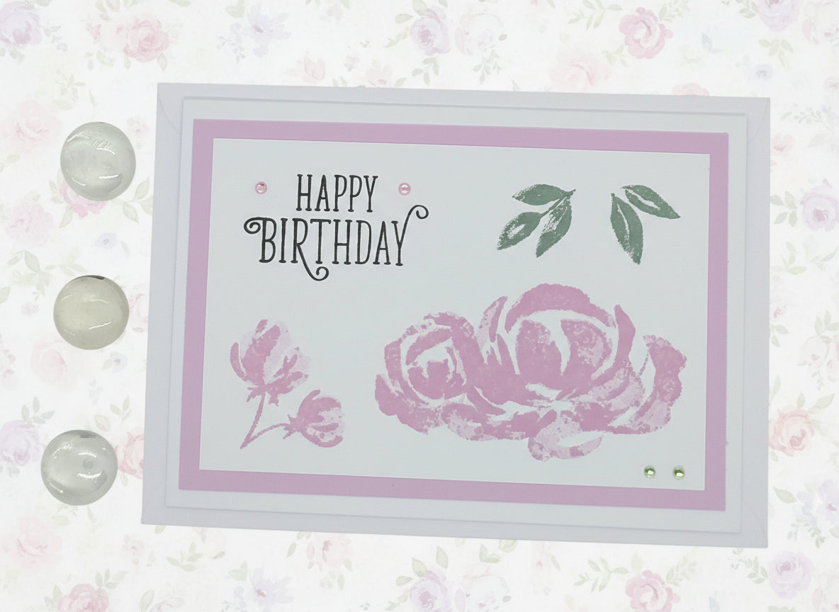 Birthday card with pink rose and 'Happy Birthday' text on a floral background