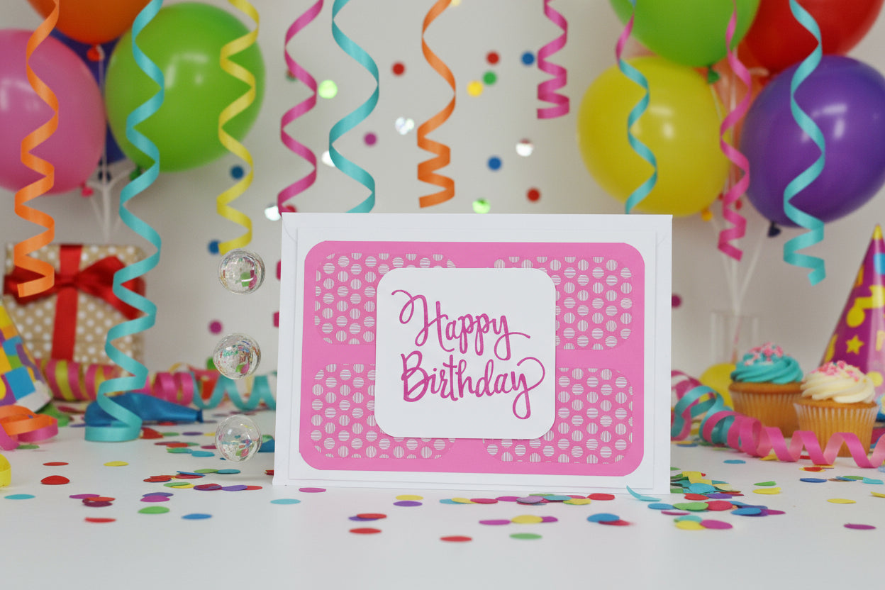 Happy Birthday card with colorful balloons and streamers in the background