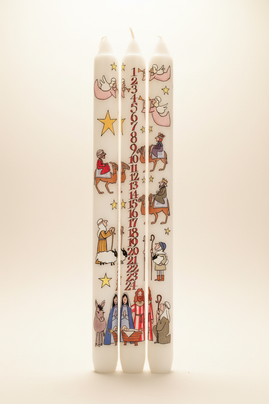 Three Nativity Advent candles with Alison Gardiner artwork on a warm off-white background