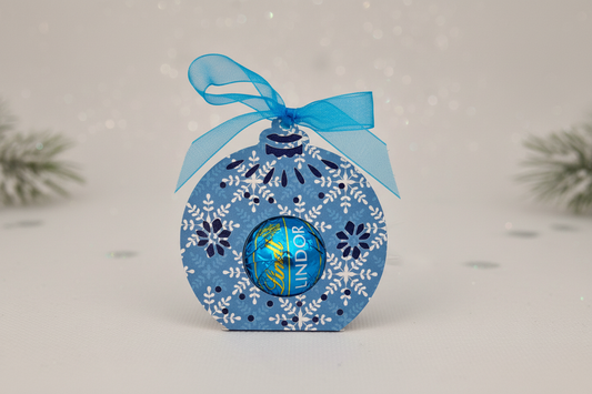 Handmade layered dark blue Christmas bauble holder with a turquoise bow and salted caramel Lindor chocolate